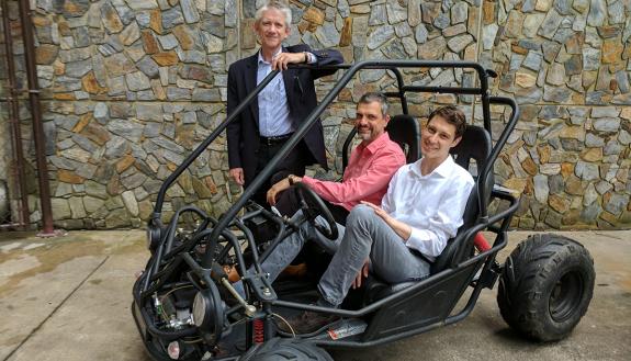 Mechanical engineering professor Josiah Knight, standing, with neuroscientists  Angel Peterchev and Stefan Goetz on right. The team’s new battery and power conversion system will be the heart of this student-built vehicle for the Shell Eco-Marathon.