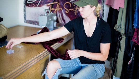 Erin Mathias plans fashions at her work desk. Photo by Pilar Timpane