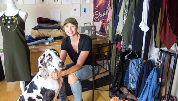 Erin Mathias, at home surrounded by her fashion work and her Great Dane Zara. Photo by Pilar Timpane