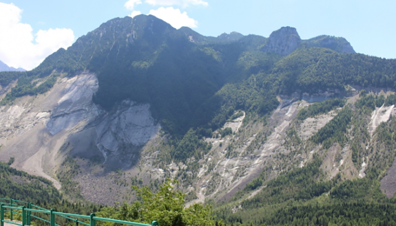 The mountainside behind the Vajont Dam in Italy is left barren where a massive landslide broke away in 1963, killing an estimated 2,000 people. Trees and other vegetation have grown on top of the landslide’s final resting place.