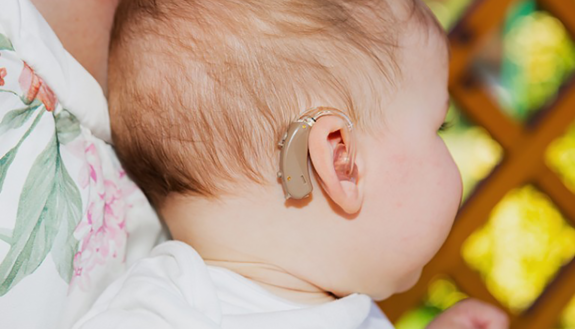 baby with a hearing aid