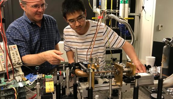Duke professor Henry Everitt and then MIT graduate student Fan Wang with the first version of a tunable terahertz laser. Everitt's "copper pipe" can be seen in the center front. The group published this first prototype in 2019. (Photo courtesy of Harvard 