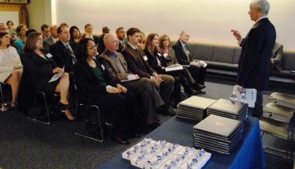 President Richard H. Brodhead, right, addresses the fourth Duke Leadership Academy class at their graduation ceremony Dec. 13.  Photo by Marsha A. Green