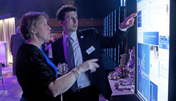 William Conescu, right, former director of Duke development communications, explores the Duke Forward website with Alice McKenzie at the Duke Forward campus launch. Photo by Duke Photography.