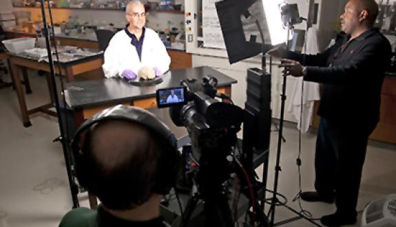 Leonard White, associate professor in the Duke Institute for Brain Sciences, films a lecture for his Medical Neuroscience class, available through Coursera. Behind the camera is Kennard Blake, videographer/editor for University Center Activities & Events