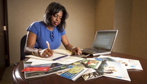 Cassandra Taylor, a Duke Credit Union financial guidance counselor, crunches numbers to squeeze more money out her budget to save for retirement.