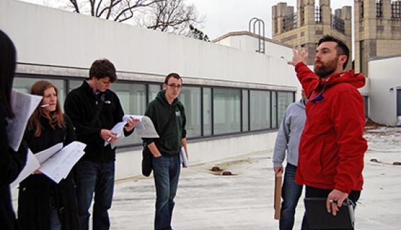 Casey Collins, energy engineer with Duke Facilities Management, leads a class of graduate students while discussing energy planning and use on campus. He and Steve Palumbo, also with Facilities, are co-teaching the class this semester. Photo by Bryan Rot