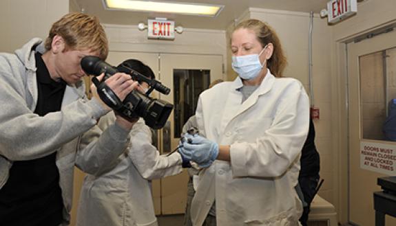 Chris Smith, education specialist at the Duke Lemur Center, video tapes a baby lemur. It's just one of his many job responsibilities at the Center that keep him invested in work and motivated. Photo courtesy of Chris Smith.
