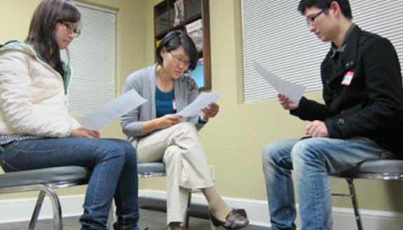 SangHee Jeong, program coordinator with the International House, center, practices her Chinese at a recent Chinese Conversation Club. It's one of sevearl weekly language and cultural learning groups offered through Duke's International House. Photo by Br