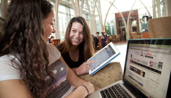 first-year students Julia Schwartz and Samantha Huff look at digital magazines using a Duke Libraries service. Photo by Jared Lazarus/Duke University Photography