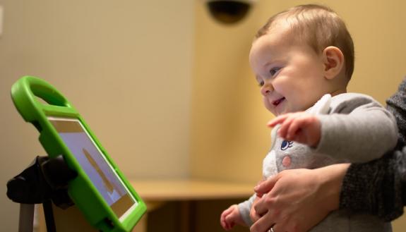 baby looks at computer screen during autism testing