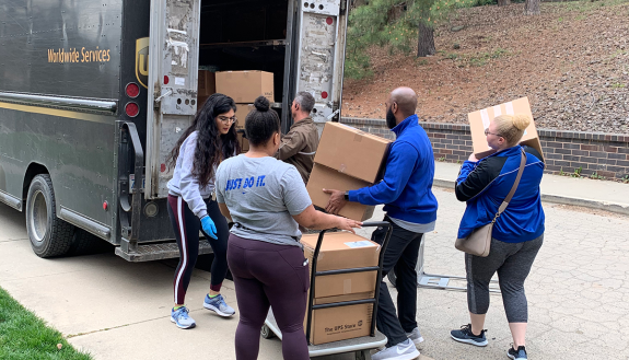duke staff move packages to be shipped to students during Spring Break week.