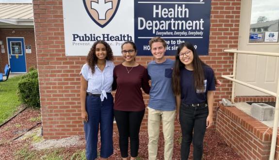 Duke students Adey Harris, Advika Kumar, Nick Haddad and Rujia Tie stand outside the health department in Pamlico County,