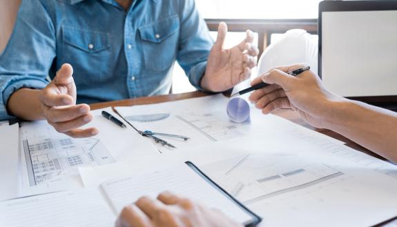 People talking at a desk.