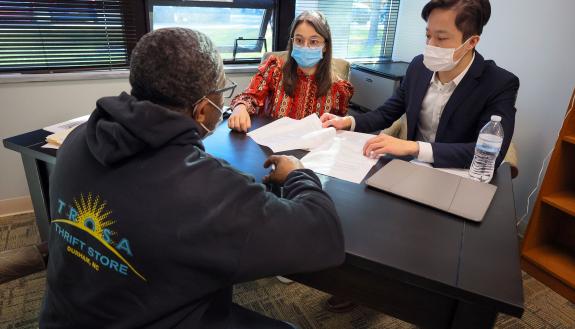 LANC attorney Rachel Smith '18 and Lok Ho JD/LLMLE '25 meeting with a TROSA resident.