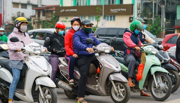 Vietnamese motorcyclists wearing masks