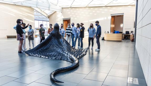 Visitors lean in for a close look at “MamaRay,” a new bronze sculpture by Wangechi Mutu at the Nasher Museum of Art. (Photo by J Caldwell)