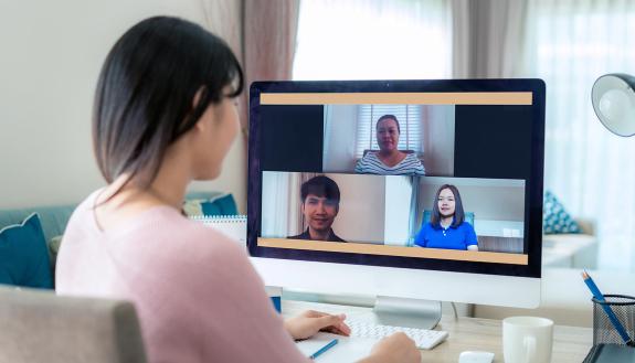 A person taking colleagues in a Zoom meeting.
