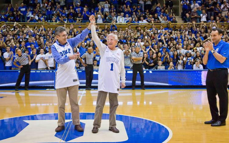 Robert J. Lefkowitz, left, stands next to fellow Duke Nobel Laureate Paul L. Modrich, when both were honored at a Duke men's basketball game. Photo courtesy of University Comms.
