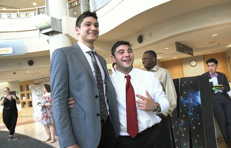 The smiles came out when Duke senior Grayson Allen visited the prom. Here he poses with patient Josh Holdner. 