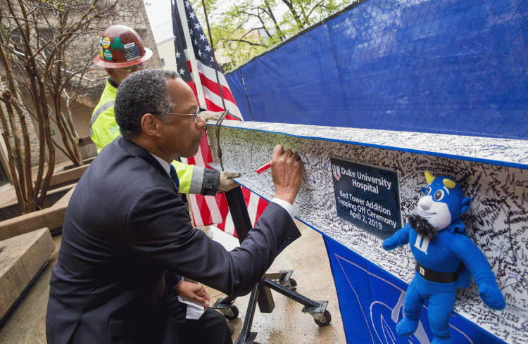 Chancellor for Health Affairs Dr. Eugene Washington signs the final beam. Photo by Shawn Rocco