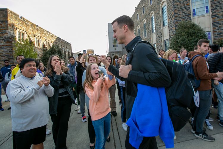 Jon Scheyer, Duke's coach next season, greets a young fan