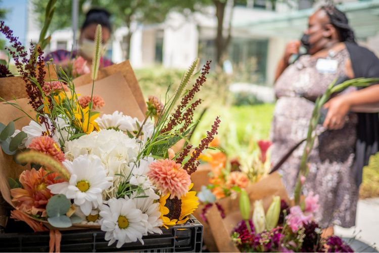 Duke employees peruse the fresh flower arrangements at Shoomee’s Flowers. Photo by William Snead.