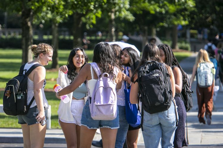 Duke students greet friends on the Abele Quad as they head to class on the first day of the Fall semester, Aug. 29, 2022. (Jared Lazarus/Duke University Communications)