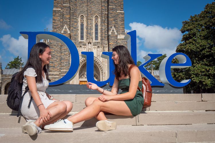 Students talk in front of the Duke sign on the first day of classes. (Bill Snead/Duke University Communications)