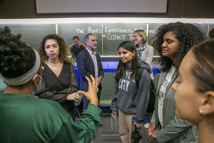After the panel discussion, from left, panelist Yumna Kamel, co-founder of Earth Refuge, talks with sophomore Meghna Parameswaran, sophomore Anya Dias-Hawkins, and Cameron Oglesby, a master of public policy student who helped organize the event. 