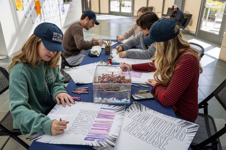 Duke Democracy Day activities included students coloring voting posters at the Nasher Museum of Art and enjoying food and live music after voting at the Karsh Alumni and Visitors Center. Here, senior Julia Deitelbaum colors a voting poster with classmates