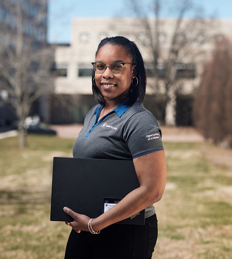 While Brittane George of the Duke University Health System Talent Acquisition team enjoys working remotely, she knows it’s important to stay connected to colleagues and campus. Photo by Alex Boerner.