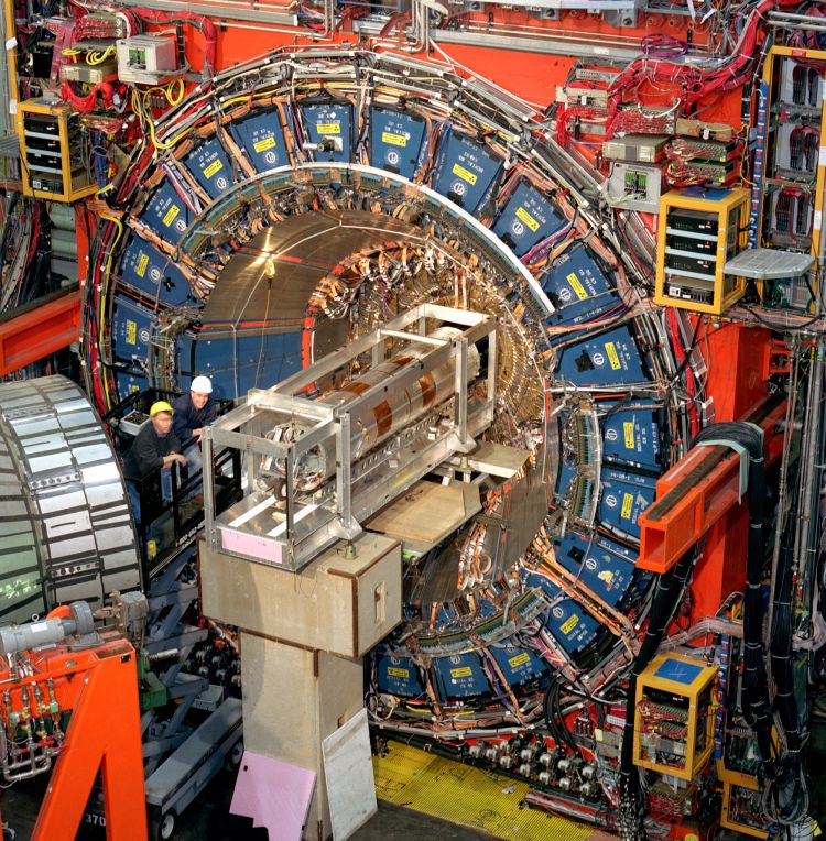 By studying the debris from head-on particle collisions inside the 3-story, 6,000-ton Collider Detector at Fermilab (CDF), researchers have made most exacting measurement yet of the mass of a short-lived particle called the W boson. Credit: Fermilab.