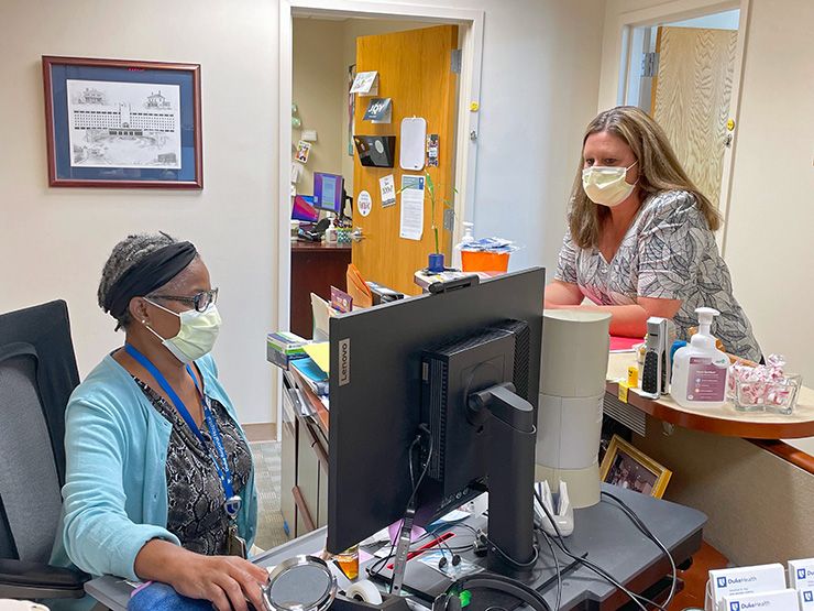 Carla Neal, right, is a source of information and encouragement for her Duke Regional Hospital colleagues.  Photo courtesy of Duke Regional Hospital.