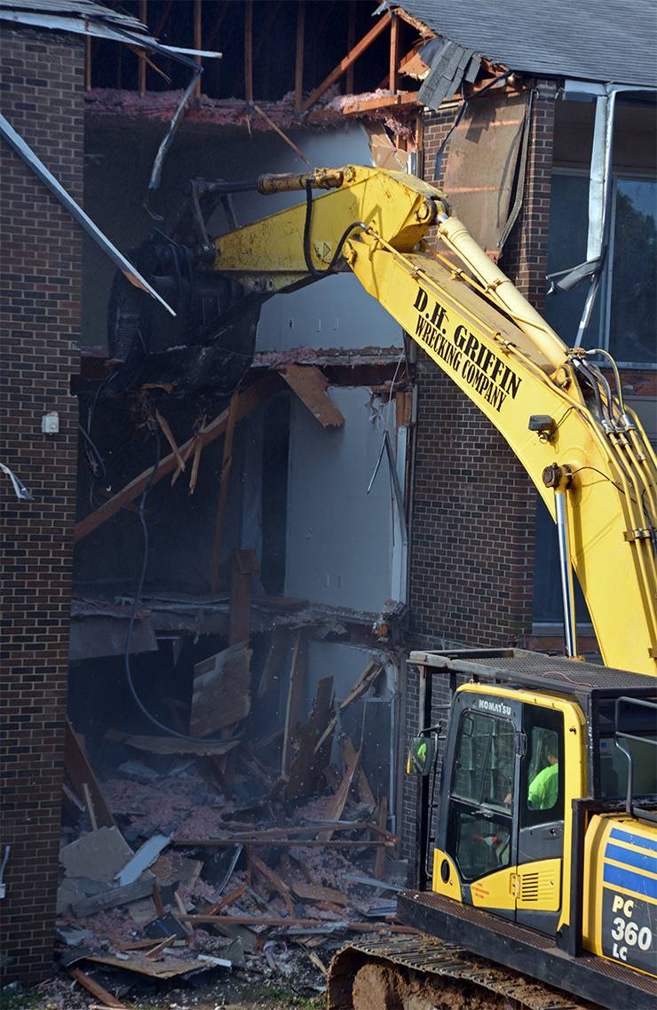 Crews demolish a former Central Campus apartment on Yearby Avenue. Photo by Jonathan Black.