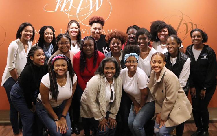 Chandra Guinn, center, poses for a photograph with students in the spring of 2019. Photo courtesy of the Mary Lou Williams Center for Black Culture.