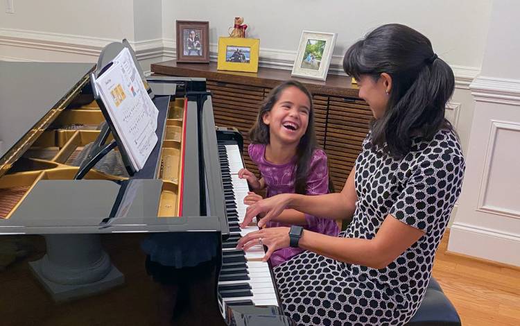 Charlene Wong no longer offers piano lessons, instead she simply enjoys playing with her children, such as daughter Emmie. Photo courtesy of Charlene Wong.