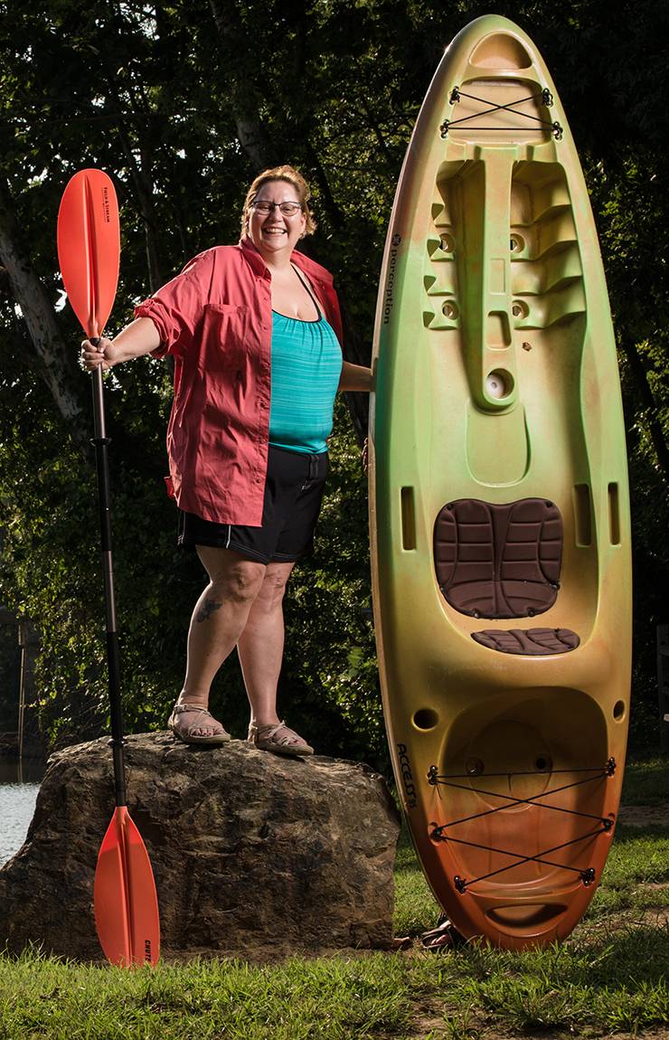 Cheryl Maxey stands next to the kayak she picked out and purchased while battling breast cancer.