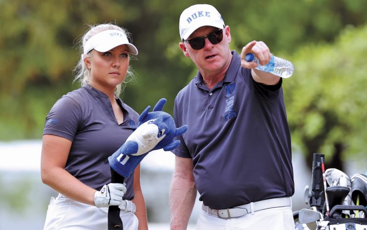 Duke Women's Golf Coach Dan Brooks, right, works with Blue Devils player Erica Shepherd earlier this season. Photo by Andy Mead.