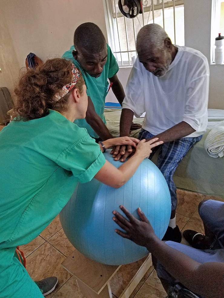 Dana Lott, left, helps a patient during a recent volunteering trip to Haiti. Photo courtesy of Dana Lott.