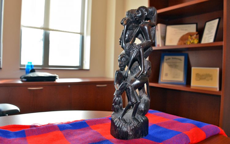 A small carved sculpture, which was a gift from his former students, reminds Brandon Knettel of his time in Tanzania. Photo by Stephen Schramm.