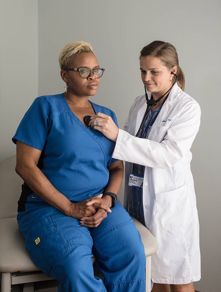 Duke Physician Assistant Jenna Brothers, right, checks the vital signs of Ebony Coley, left, during a recent appointment.