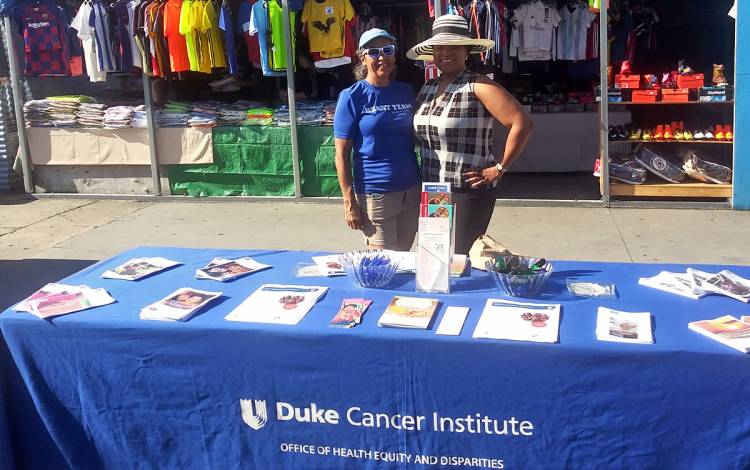 The Office of Health Equity's Kearston Ingraham, right, stands with one of her community partners at an event at a pre-pandemic flea market. Photo courtesy of the Office of Health Equity.