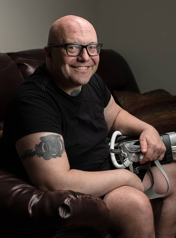 John Nocero holds the CPAP machine that has helped him overcome obstructive sleep apnea.