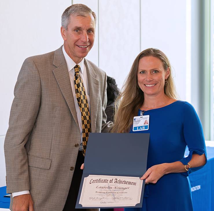 Laurelin Younger, right, stands with Duke Vice President of Administration Kyle Cavanaugh after earning her Training Certificate of Excellence last year. Photo courtesy of Laurelin Younger.