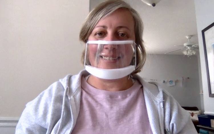 Leigh Fickling, director of Duke Disability Management System, models one of the transparent masks available for employees, students and guests to wear when communicating with people with hearing loss.