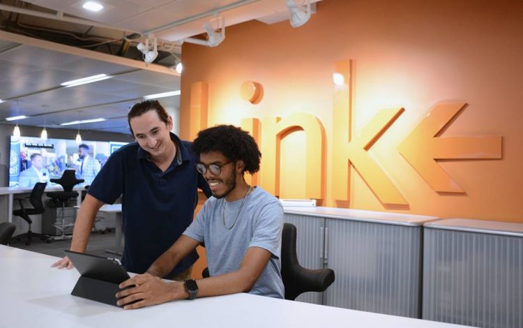 The Link is an in-person option for receiving IT help from people like Duke OIT's Sean Muchmore, left, helping someone in July 2021. Photo by Stephen Schramm.