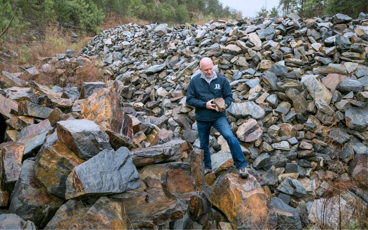 Paul Manning examines a stone at Duke's quarry. Photo by Jared Lazarus.