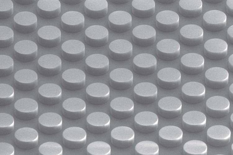 A dimpled surface with cylinders like the face of a Lego brick forms a non-metallic conductive material. The metamaterial absorbs electromagnetic energy without heating. A dimpled surface with cylinders like the face of a Lego brick forms a non-metallic conductive material. The metamaterial absorbs electromagnetic energy without heating.