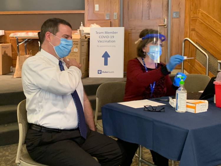 Dr. Owens, President of Duke University Health System readies for his first dose of the Pfizer COVID vaccine